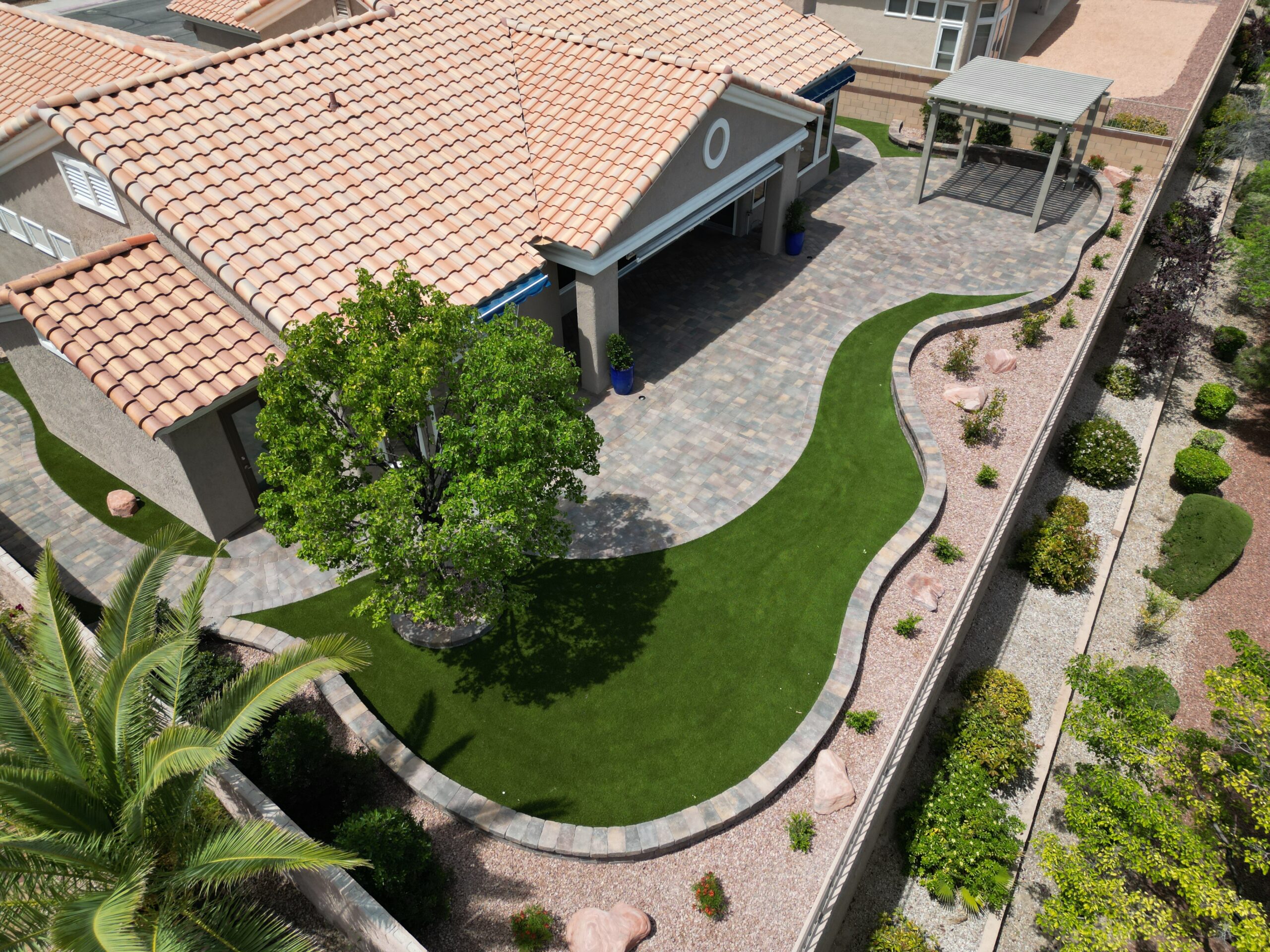 A bird 's eye view of a backyard with a lawn. A bird 's eye view of a backyard with a lawn.