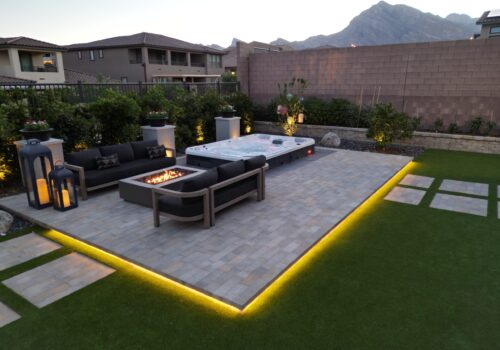 A patio with a fire pit and couch in it