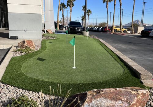 A golf hole with a green on the side of it.