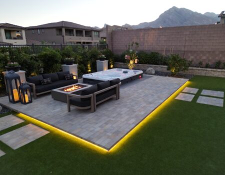 A patio with a fire pit and couch in it