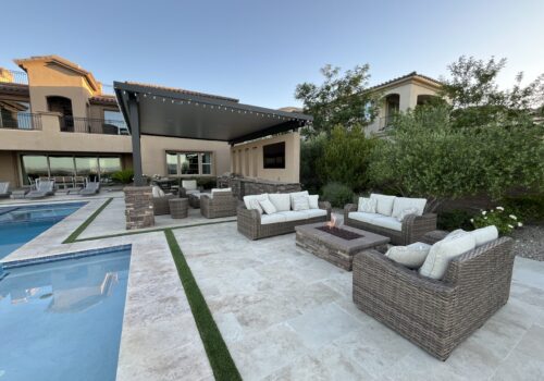 A large backyard with a pool and patio furniture.