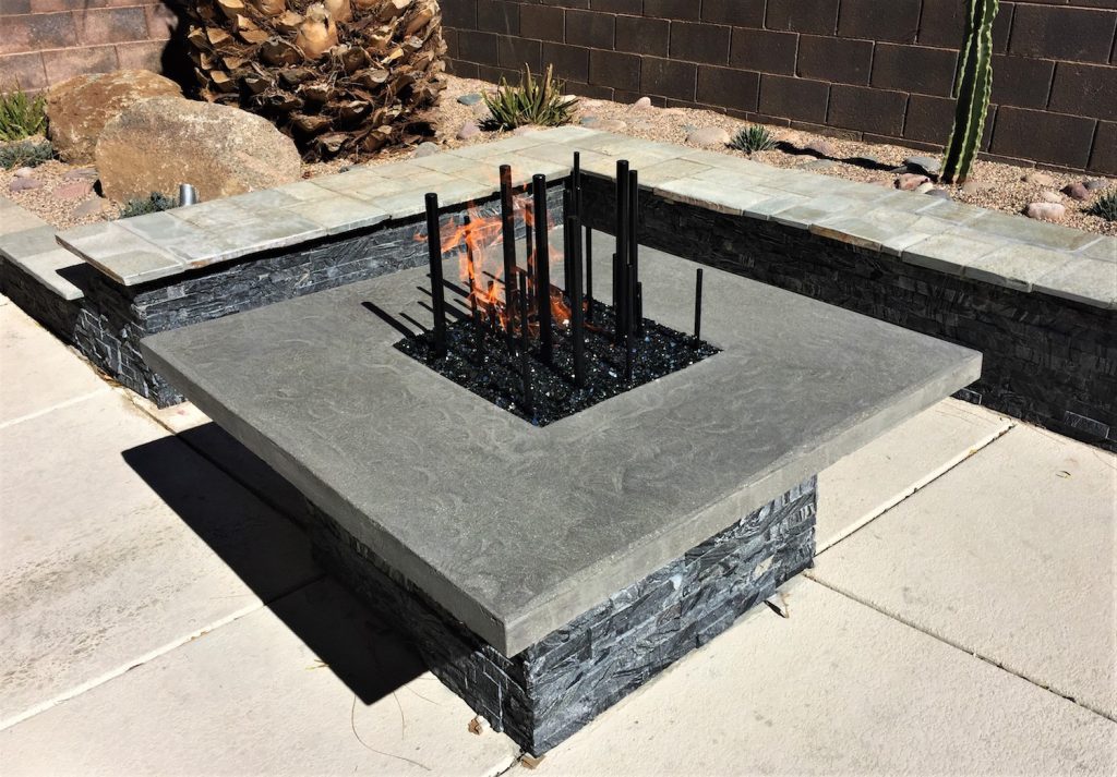 A fire pit with metal grate and stone base. A fire pit with metal grate and stone base.