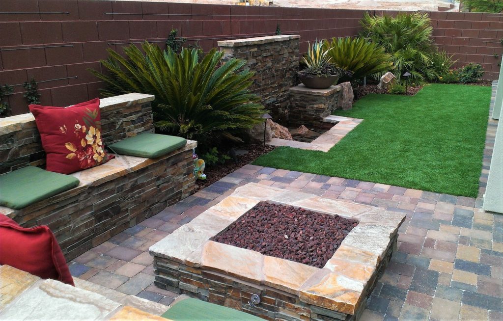 A fire pit sitting in the middle of a patio. A fire pit sitting in the middle of a patio.