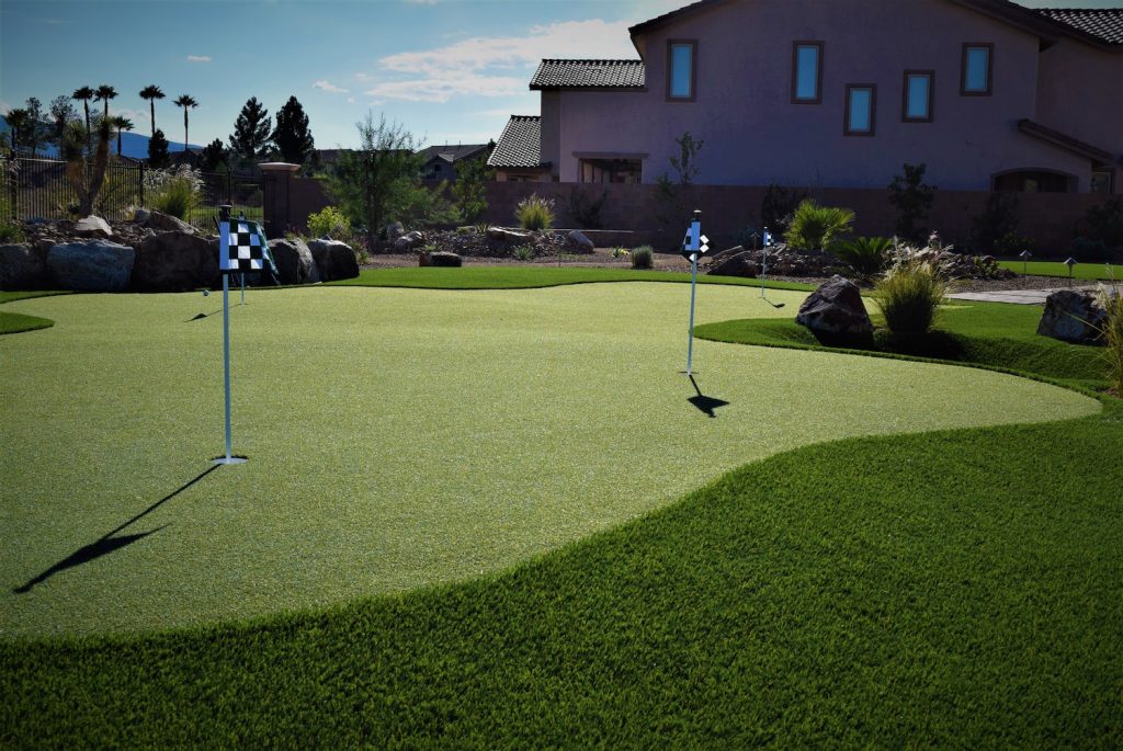 A golf course with a green and some flags A golf course with a green and some flags